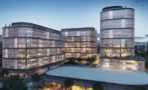 הדמיית ערב של מתחם ACRO BUSINESS CAMPUS עם קומות מוארות וכיכר מסחרית בבסיס - תג נכסים