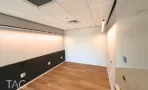 חדר ישיבות בACRO BUSINESS CAMPUS עם פרקט עץ, חיפוי קיר כהה ותאורה שקועה - תג נכסים