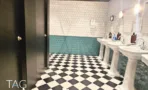 משרדים להשכרה במגדל רוגובין תדהר - חדר שירותים עם ריצוף משבצות שחור לבן, אריחים ירוקים ושלושה כיורים - תג נכסים