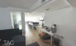 חלל עבודה פתוח עם עמוד בטון ושורת עמדות במשרד להשכרה באזור עזריאלי