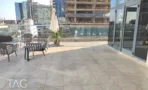 גג פרטי במשרד להשכרה בשדרות רוטשילד תל אביב - ריצוף חוץ אפור, שמשייה ופינת ישיבה - תג נכסים
