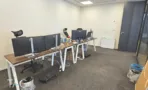 חלל עבודה במשרד במגדל ספיר עם שולחנות ארוכים ומסכים כפולים