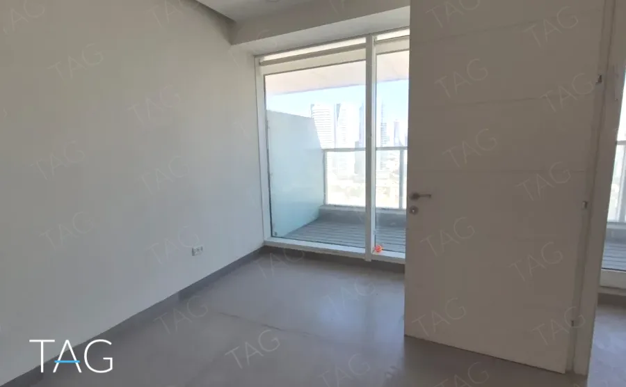 חלל משרד ריק עם רצפת בטון ויציאה למרפסת, משרד 120 מ