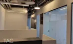 משרד להשכרה 160 מ״ר במגדלי אלון, חלל כניסה בעיצוב תעשייתי עם תקרה חשופה ומחיצות זכוכית