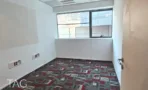 חדר ריק עם שטיח מודולרי בגווני אדום ואפור, חלון פינתי וקירות לבנים - משרד 918 מר, אריה שנקר מרכז גב ים הרצליה - תג נכסים