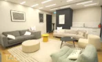 פינת לאונג' עם ספות אפורות, תמונות ממוסגרות ומטבחון