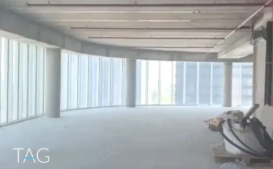 קומת מעטפת בACRO BUSINESS CAMPUS עם תקרת בטון, עמודים וחלונות היקפיים - תג נכסים