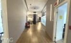 מסדרון עם פרקט אלון ודלת זכוכית לחדר עבודה במשרד להשכרה ליד רכבת השלום - תג נכסים
