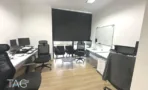 חדר ישיבות עם לוח מחיק ושולחנות עבודה במשרד להשכרה ליד רכבת השלום - תג נכסים