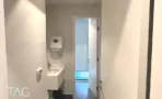 חדר שירותים עם כיור ודלת לבנה