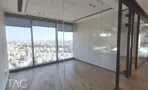 חלל פתוח ריק עם קיר מסך ופרקט במשרד 330 מ״ר במגדל רסיטל