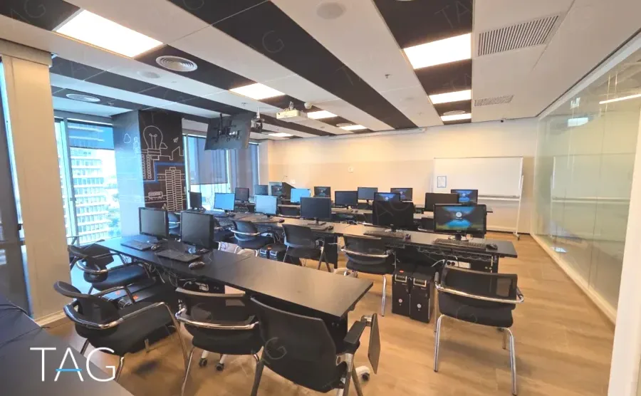 חדר הדרכה במשרד להשכרה במגדל אלייד בבני ברק עם עמדות מחשב ולוח מחיק - תג נכסים