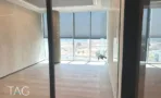משרד בACRO BUSINESS CAMPUS עם קיר טיח מרוח, וילונות גלילה ופרקט עץ - תג נכסים