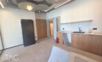 מטבחון בACRO BUSINESS CAMPUS עם ארונות עץ, כיור ותקרה מעוצבת - תג נכסים