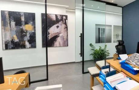 חדר עבודה עם מחיצת זכוכית במסגרת שחורה ותמונות אמנות על הקיר, משרד להשכרה במגדל סקיי טאוור