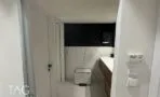 חדר שירותים מחופה אריחים בדוגמת שיש עם ארון כיור מעץ, משרד להשכרה ליד הבימה